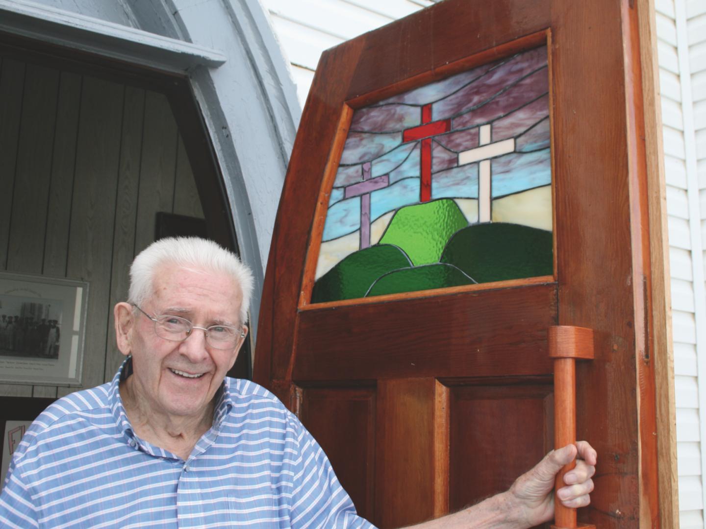 Eric Parsons by the doors of Freshwater (N.L.) United, which he had recently refinished, in July 2019. (Photo: Denise Flint)